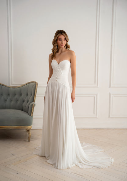 "Flowing A-line wedding dress with train, full length front view"