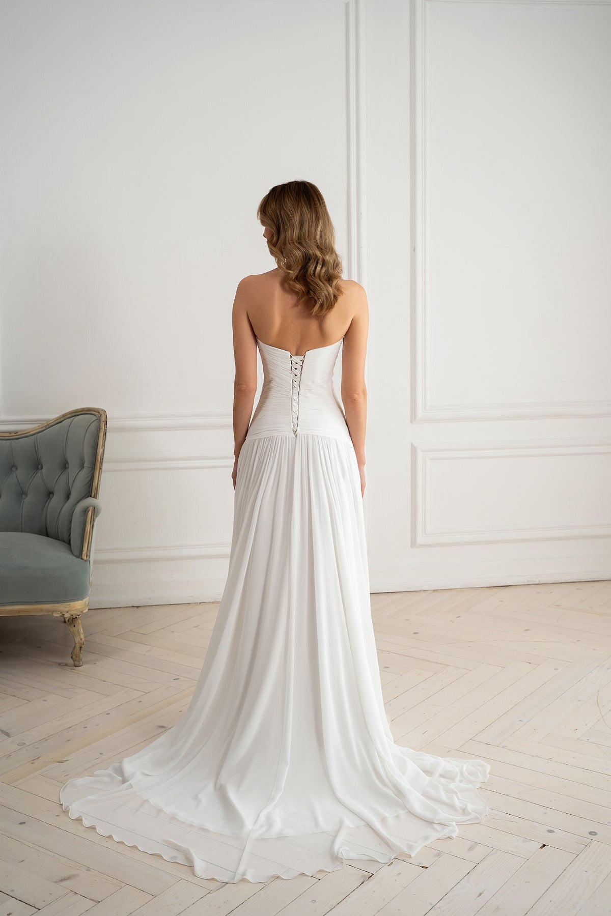 Corset lace-up back detail on strapless chiffon wedding dress"