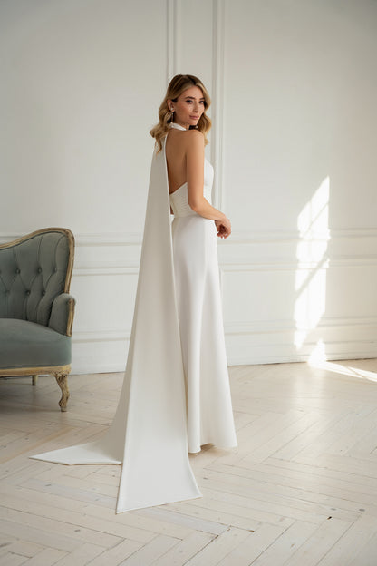 "Bride wearing minimalist halter neck wedding dress with pleated waist"
