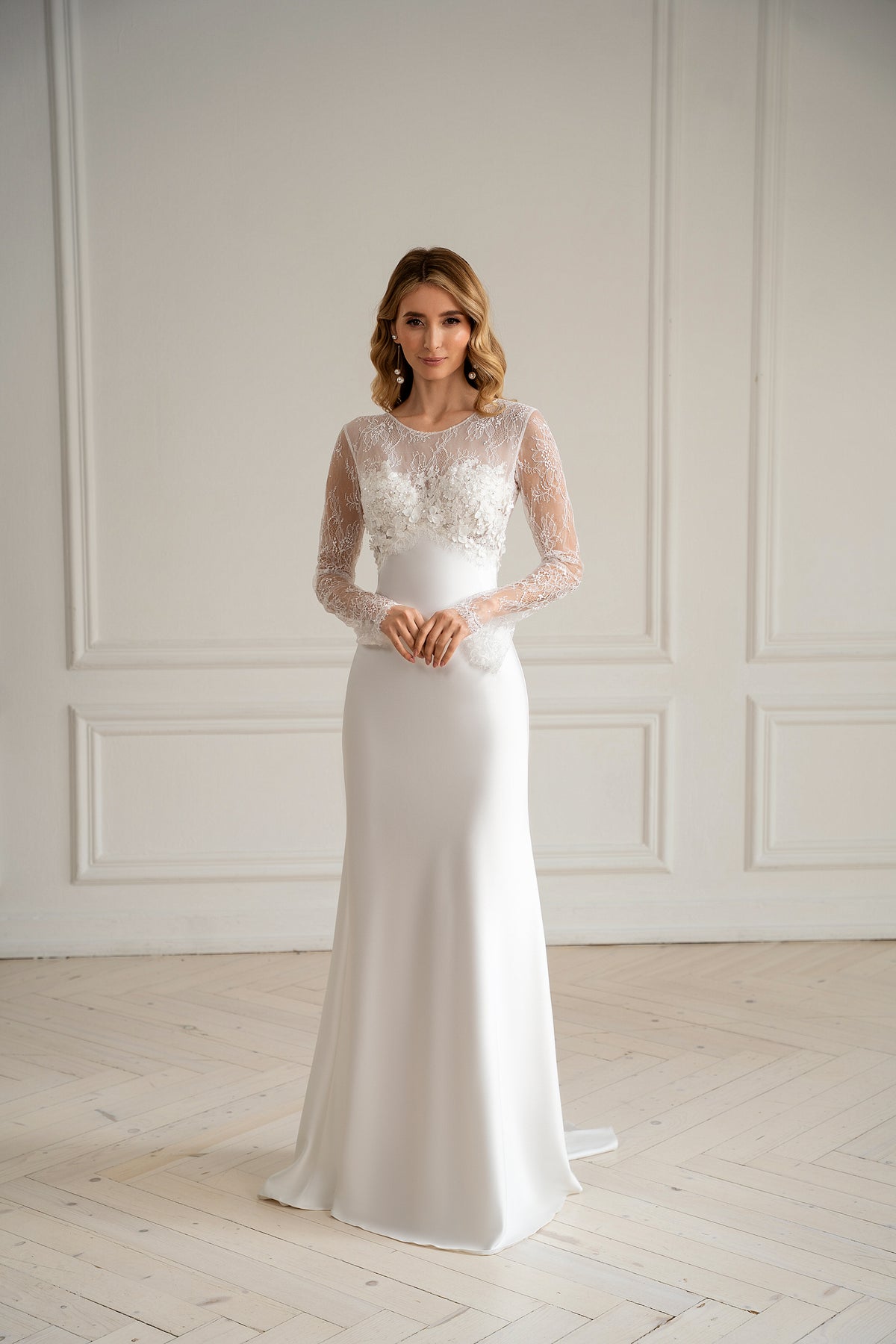 "Bride in long sleeve lace wedding dress with 3D floral bodice, front view"