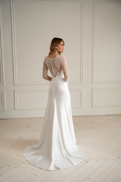 "Bride in long sleeve lace wedding dress with 3D floral bodice, front view"