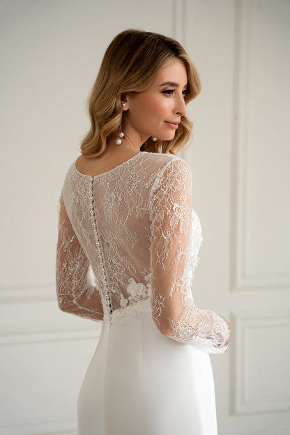 "Bride in long sleeve lace wedding dress with 3D floral bodice, front view"