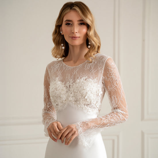 "Bride in long sleeve lace wedding dress with 3D floral bodice, front view"